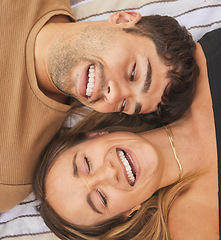 Image showing Above, love and couple with a smile on a blanket at a park during a date, holiday or picnic. Comedy, happy and face of a funny man and woman laughing on a vacation together on the ground in nature