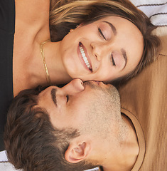 Image showing Couple, kiss and smile with love and care in romantic overhead, happy together and bonding for healthy relationship. Man, woman and happiness, face and eyes closed with romance and quality time.