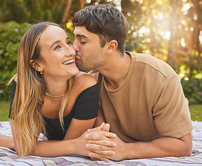 Image showing Couple, holding hands with kiss and love in the park, picnic for bonding and happy in nature together. Support, trust and care with romantic date and outdoor fun, commitment and happiness.