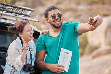 Image showing Couple, travel and road trip selfie with peace sign, map and smile while on a stop outdoor for social media streaming on vacation, journey and adventure. Asian, woman and man together for phone photo