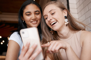 Image showing Social media, communication and friends with a comic mobile app on a phone at a cafe. Website, internet and women with a mobile streaming and speaking about a funny video on the web at a coffee shop