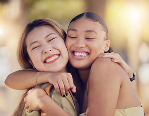 Image showing Friends, women and hug for love, care and support while outdoor for travel, happiness and bonding with asian and black woman. Lesbian couple with a smile in nature for peace, summer and time together