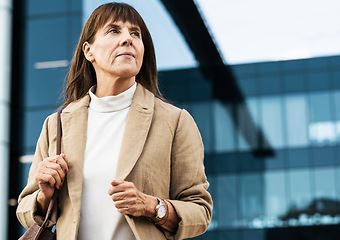 Image showing City, office and senior business woman waiting for a lift, taxi or cab outside the corporate building. Serious, professional and elderly manager standing alone outdoors in the street in a urban town.