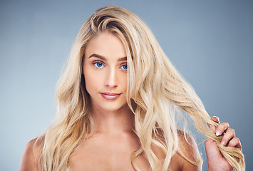 Image showing Woman, blonde, hair care on gray studio background in hair dye advertising, treatment or texture hair style. Portrait, beauty model or face with makeup cosmetics, healthy skincare or long hair growth