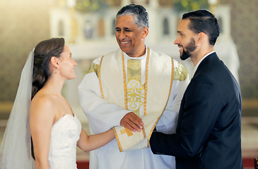 Image showing Wedding, priest and couple holding hands in church for a christian marriage oath and faithful commitment. Trust, bride and happy groom with a supportive pastor helping them make a holy love promise