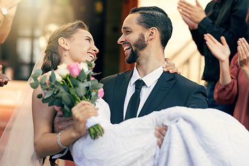 Image showing Love, wedding and man carrying woman at church after marriage ceremony with applause of friends and family. Happy, smile and celebration of married bride and groom after event with audience clapping.