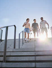 Image showing Diversity, skateboard friends or fitness people walking down stairs for wellness, workout or skating training in city street. Happy, smile or male skater at park for exercise, health or sports