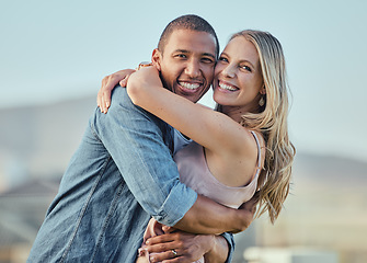 Image showing Happy interracial couple, hug and portrait smile for relationship happiness, travel or bonding in the outdoors. Man and woman hugging, smiling and enjoying time together for love, support and care