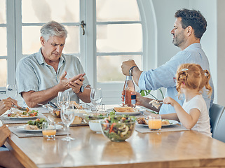 Image showing Lunch, dining room and family eating together in celebration at a modern home with food and champagne. Hurt grandfather in retirement, father and child enjoying a food meal at a dinner table at house