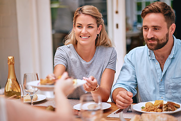 Image showing Family, food and eating together, couple have meal at family home for celebration or weekend lunch. Relax, happy and smile while bonding, party or holiday dinner with happiness and nutrition.