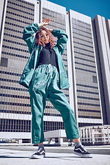 Image showing Black woman, hip hop fashion and city gen z girl with urban style, designer streetwear and edgy clothing. Modern clothes, portrait of confident street model and posing by town building in Brazil sun