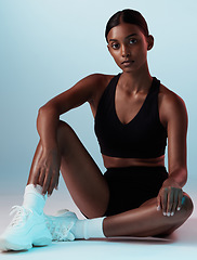 Image showing Woman, fitness or posing on blue background in studio in gym clothes with health goals, wellness mindset or sports target. Portrait, model or personal trainer with exercise, training and workout idea