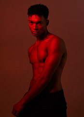 Image showing Black man, body and dark light on red background in studio for exercise, training or workout bodybuilder, personal trainer or coach. Portrait, fitness model or red light aesthetic for health wellness