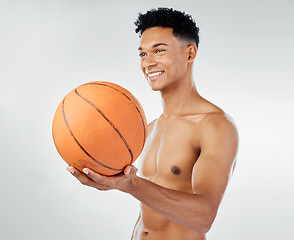 Image showing Basketball, fitness and black man in studio training, exercise and wellness with smile for sports competition. Power, muscle and happy athlete, basketball player or model with a ball for game workout