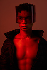 Image showing Cool, cyberpunk and man with glasses for futuristic style, fashion and creative digital design in a neon room with studio background. Aesthetic art, dark and model with red lighting for creativity