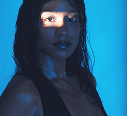 Image showing Beauty, portrait and shadow girl with spotlight for skin health, skincare or cosmetic advertising. Sweaty, edgy and natural cosmetics black woman with blue studio background for marketing.