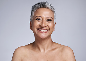 Image showing Face, beauty and skincare with a mature woman in studio on a gray background for natural antiaging care. Portrait, luxury and skin with a female model posing to promote wellness or cosmetic product