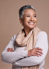 Image showing Fashion, thinking and style with a senior woman in studio on a brown background to model a contemporary brand. Idea, smile and trendy with a mature female posing to promote clothing or clothes