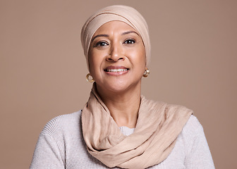 Image showing Muslim, hijab and arab ,woman in studio for beauty, religion and happiness for cosmetics, makeup and fashion on a brown background. Face portrait of a female with a smile for skincare with a glow