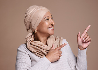 Image showing Mature islam woman, pointing or advertising mock up, marketing space or studio background mockup. Happy smile, muslim model or fashion hijab scarf in promotion deal or product placement hand gesture