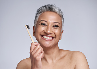 Image showing Dental, woman with toothbrush for hygiene with smile and grooming portrait, oral health and clean against studio background. Mature, dental care and whitening, fresh breath and healthy teeth mockup.