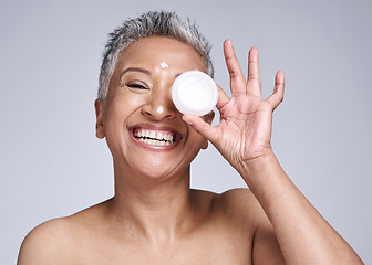 Image showing Skincare, beauty and happy woman with face cream for her skin routine with natural product in a studio. Happiness, smile and portrait of a senior lady with facial lotion isolated by a gray background