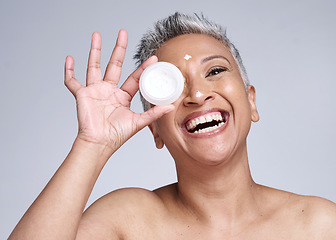 Image showing Mature woman, laughing and skincare cream in healthcare grooming, collagen glow wellness or facial dermatology routine. Smile, happy or beauty model with sunscreen product on Indian studio background