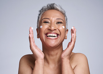 Image showing Happy senior woman with skincare, beauty and healthy cosmetic skin with anti aging facial moisturizer cream. Portrait of health self care, lotion on face and smile in grey mockup studio background