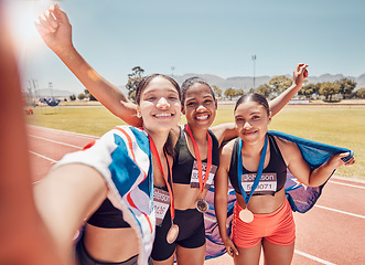 Image showing Selfie, medal and friends with a British flag after running, fitness and sports at a stadium. Collaboration, winning and women athlete group with a photo after achievement in sport or marathon