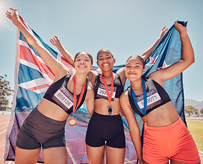 Image showing Athlete, champion and winning group of women holding new Zealand flag and medal after competition, marathon and running at stadium. Portrait of diversity female runners happy about win or achievement