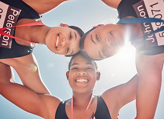 Image showing Sports, teamwork and fitness with a girl group standing in a circle huddle on a blue sky from below. Health, face and portrait with a female team together for wellness, exercise or training outdoor