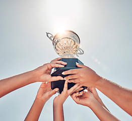 Image showing Teamwork, sports and hands of people with trophy for winner, achievement and champion success. Support, community and diversity with women and award for training, commitment and collaboration