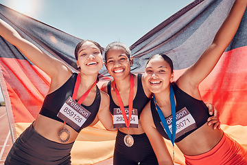 Image showing Award, running and team of women with flag of Germany for winner, gold medal or training in stadium racetrack event. Fitness, goals or sports with portrait of girl runner for global marathon champion