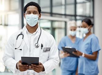 Image showing Covid, healthcare and African doctor with a tablet for online consulting, agenda and planning on tech at hospital. Medical, portrait and surgeon with technology for schedule and face mask at a clinic