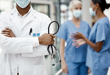 Image showing Black man, doctor and stethoscope for health, crossed arms and for wellness in hospital. Medical professional, nurses and health with equipment for checkup, examine and healthcare in workplace.