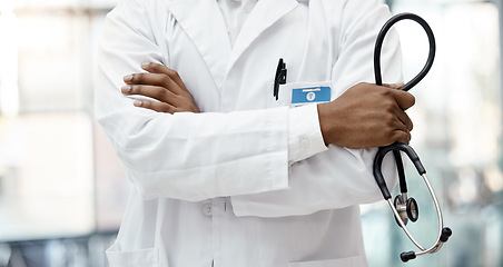 Image showing Healthcare, hospital and hands of doctor with stethoscope standing in clinic with arms crossed. Leadership, support and african american health care worker with medical equipment for innovation