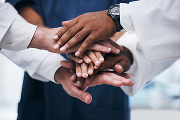 Image showing Hands, teamwork and unity with a business team of diversity standing in office with a hand each in a huddle, stack or pile. Trust, partnership and solidarity with an employee group working together