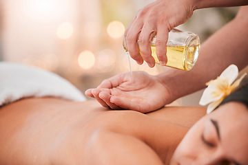 Image showing Hand, oil and massage on woman at a spa for wellness, relax and stress relief with back massage and masseuse. Luxury, back and girl hands of therapist with product for body, skin and muscle therapy