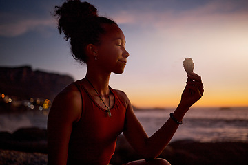 Image showing Beach meditation, sunset and yoga woman with sage aromatherapy smoke for aura, soul or chakra energy healing. Zen mindset, pilates mindfulness and black girl meditate for twilight spiritual balance