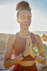 Image showing Meditation, calm and woman doing exercise at the beach for wellness, peace and relaxation. Nature, fitness and black woman with hands together doing workout for zen, mental health and energy by ocean