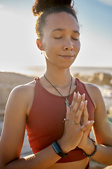 Image showing Yoga, meditation and praying black woman at beach for spiritual, wellness and healing with zen, nature and mindfulness. Sports, calm and prayer hands girl meditate for faith, peace and health by sea