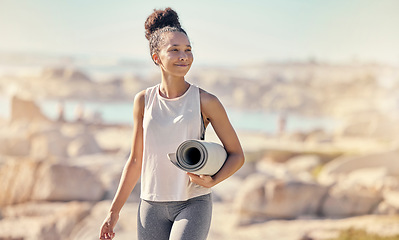 Image showing Beach, yoga mat and black woman with smile outdoor for meditation, wellness and peace to relax. African American female, lady and seaside walking, health or pilates for exercise, calm or seaside view