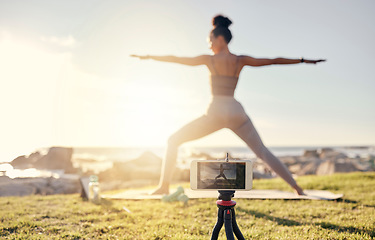 Image showing Yoga, fitness and live streaming woman smartphone in nature for social media, influencer blog or wellness content creation. Stretching, pilates and fitness content creator girl with videography app