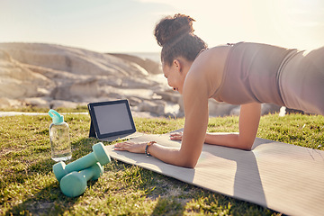 Image showing Fitness, woman and tablet in yoga planking at the beach for exercise, training or workout in healthy wellness. Active female in plank pose for abdominal, abs or core strength with touchscreen outside