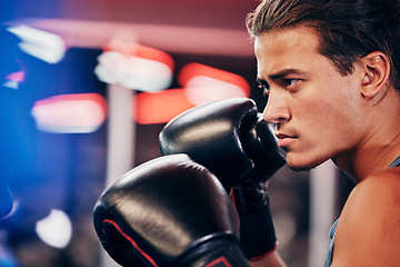 Image showing Fitness, profile and boxer training in gym for match or competition. Side view, boxing sports or serious male athlete in fitness center practicing punch, exercise or workout for game, fight or battle