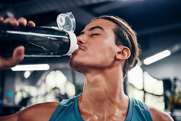 Image showing Man, drinking water and training exercise in sports gym for healthy lifestyle. Tired athlete, fitness workout and wellness motivation or bodybuilder cardio rest and water hydration in health club