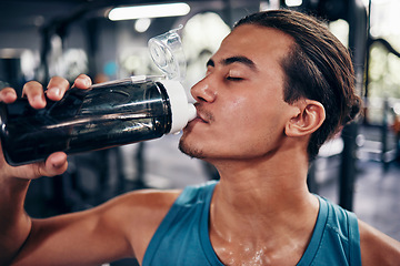 Image showing Drinking water, fitness and gym man with challenge workout training for muscle, power and energy with motivation, goals and sweating. Tired sports, athlete person with water bottle in health exercise