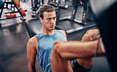 Image showing Fitness, gym and man on leg press machine training legs and thigh muscles for powerful lower body strength. Focus, healthy and strong young athlete serious about a exercise workout program in a club