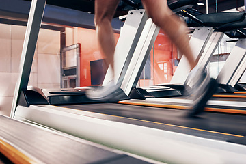 Image showing Fitness, treadmill with man running on machine for exercise, cardio training and workout for cardiovascular and heart health. Legs of athlete with energy, speed and commitment for a fast speed run