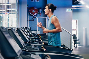 Image showing Treadmill, running and profile of man in gym for cardio workout and heart health. Fitness, sports and male runner on machine practicing for marathon, race or training for wellness in fitness center.